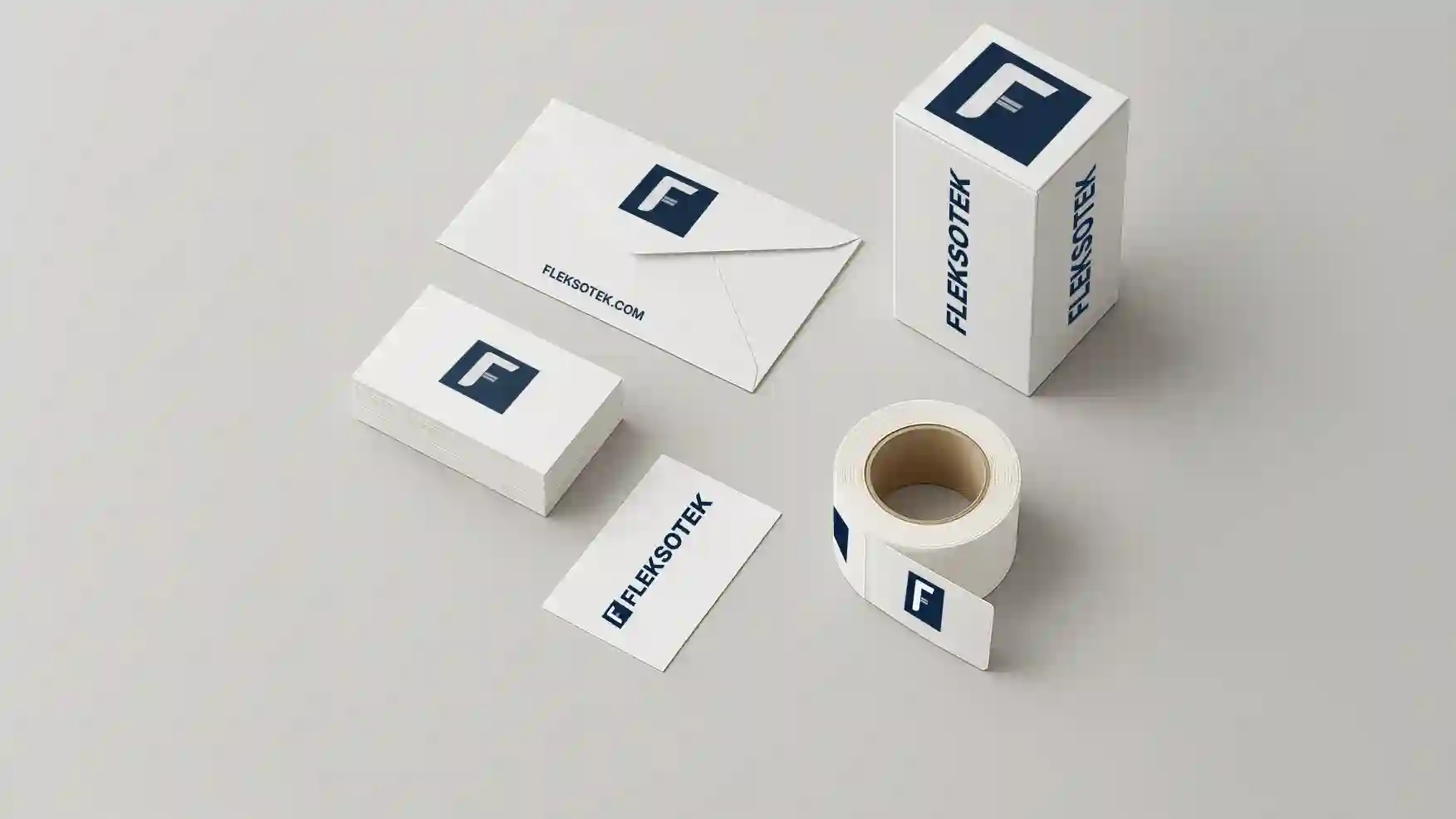 Minimalist branding mockup featuring the Flekstek logo on an envelope, business cards, a packaging box, and a label roll on a light background.